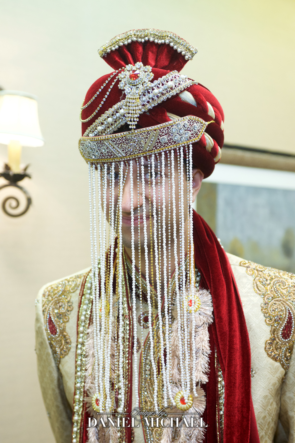 Indian groom wearing traditional turban and sehra in a vibrant wedding ceremony